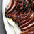 Image of skirt steak and on white plate with fork